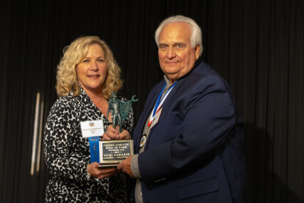 Tim Samarin with Gena Behrens accepting Vicki Samarin's award