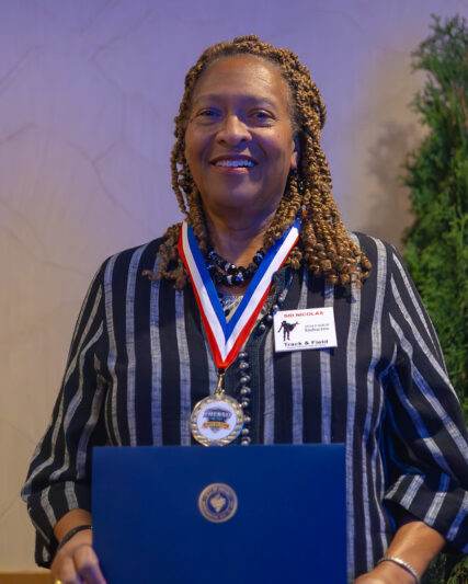 Ivy Nickolas smiling with Sid's medal