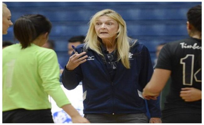Vicki Samarin in discussion with her volleyball players during a match