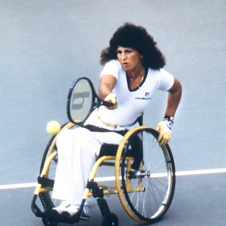 Marilyn Hamilton Marilyn Hamilton on the court hitting a tennis ball in match from her wheelchair