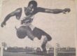 Sid Nikolas long jumping over a hurdle in Track and Field