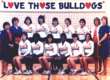 1984 Fresno State Volleyball Team lined up in two rows with their coaches with a banner reading "Love those bulldogs" behind them